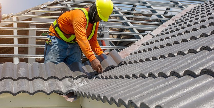 roof replacement by roofing expert in safety wear and safety helment at one of the melbourne's house.