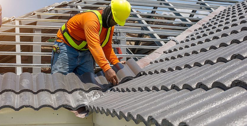 roof replacement by roofing expert in safety wear and safety helment at one of the melbourne's house.