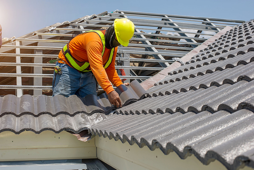 roof replacement by roofing expert in safety wear and safety helment at one of the melbourne's house.